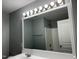 Bathroom showcasing a large mirror, vanity with sink, and tub with shower at 4423 Sugarbend Way, Raleigh, NC 27606