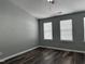 Spacious bedroom with wood-look floors and large windows providing natural light at 4423 Sugarbend Way, Raleigh, NC 27606