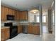 Bright kitchen showcasing stainless steel appliances, wood cabinets, and access to the living area at 4423 Sugarbend Way, Raleigh, NC 27606