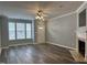 Bright living room with luxury vinyl flooring, large window, and cozy fireplace at 4423 Sugarbend Way, Raleigh, NC 27606