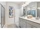 Bright bathroom featuring double sinks, white cabinets, and a walk-in shower with glass door at 49 Olivia Crossing Ct # 43, Four Oaks, NC 27524