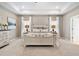 Bright and airy main bedroom featuring neutral color palette, tray ceiling, and lots of natural light at 49 Olivia Crossing Ct # 43, Four Oaks, NC 27524