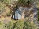 Aerial view of a gray roof house with a long driveway surrounded by trees at 5120 Knaresborough Rd, Raleigh, NC 27612