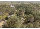 An aerial view of a property surrounded by mature trees in a quiet neighborhood at 5120 Knaresborough Rd, Raleigh, NC 27612