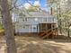 Exterior view of the home with a screened porch overlooking the spacious backyard at 5120 Knaresborough Rd, Raleigh, NC 27612