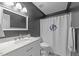 This bathroom features a white marble vanity and a shower with a monogrammed curtain at 5120 Knaresborough Rd, Raleigh, NC 27612