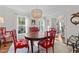 The dining room offers bright windows, hardwood flooring, and a decorative chandelier at 5120 Knaresborough Rd, Raleigh, NC 27612