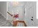 Bright entryway features hardwood floors, staircase, and an elegant chandelier visible through the dining room at 5120 Knaresborough Rd, Raleigh, NC 27612