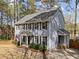 Beautiful exterior view of home highlighting siding, black shutters, landscaping and side entry at 5120 Knaresborough Rd, Raleigh, NC 27612