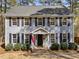 Charming two-story home with black shutters, gray siding, and well-manicured landscaping at 5120 Knaresborough Rd, Raleigh, NC 27612