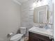 Updated half bathroom with stylish shiplap wall, modern vanity, and fixtures at 5120 Knaresborough Rd, Raleigh, NC 27612