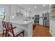 Bright kitchen features white cabinets, stainless steel appliances, and bar seating at 5120 Knaresborough Rd, Raleigh, NC 27612