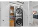 Convenient laundry area with modern washer/dryer units and shelving for storage at 5120 Knaresborough Rd, Raleigh, NC 27612
