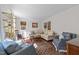 Cozy living room featuring hardwood floors, neutral-toned furniture and an abundance of natural light at 5120 Knaresborough Rd, Raleigh, NC 27612