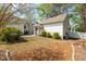 A view of the backyard and patio with its outdoor seating area, garden, and mature trees at 524 Beckwith Ave, Clayton, NC 27527