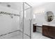 This bathroom has a glass shower with white tile and dark brown cabinets at 524 Beckwith Ave, Clayton, NC 27527