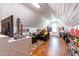 Spacious bonus room with hardwood floors, a cozy seating area, and great natural light at 524 Beckwith Ave, Clayton, NC 27527