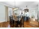 Dining room featuring rustic wood table, light fixture, and adjacent kitchen at 524 Beckwith Ave, Clayton, NC 27527