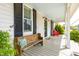 Inviting front porch with a cozy wooden bench and colorful pillows, perfect for relaxing at 524 Beckwith Ave, Clayton, NC 27527
