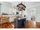 Island kitchen boasts modern appliances, pot rack, granite countertops, and plenty of light at 524 Beckwith Ave, Clayton, NC 27527