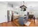 Bright kitchen featuring stainless steel appliances, island, and overhead pot rack at 524 Beckwith Ave, Clayton, NC 27527