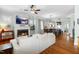 Open-concept living room with fireplace, TV, ceiling fan, and hardwood floors at 524 Beckwith Ave, Clayton, NC 27527