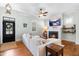 Cozy living room with a fireplace, modern furniture, and ample natural light, and beautiful hardwood floors at 524 Beckwith Ave, Clayton, NC 27527