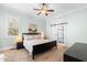 Inviting bedroom with ensuite bathroom featuring barn door entry and large window at 524 Beckwith Ave, Clayton, NC 27527
