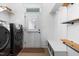 Functional mud room with washer/dryer, storage, and door to the outside at 524 Beckwith Ave, Clayton, NC 27527