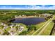 Scenic aerial view of a neighborhood with a lake, homes, and lush green landscaping at 53 Stafford Cir, Clayton, NC 27527