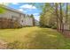 Spacious backyard featuring a well-maintained lawn and mature trees, offering ample space for recreation at 53 Stafford Cir, Clayton, NC 27527