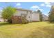 Large backyard with well-maintained lawn, wooden deck, and mature trees, perfect for outdoor activities at 53 Stafford Cir, Clayton, NC 27527