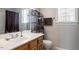 Bathroom featuring a single sink vanity, mirror, and convenient shelving at 53 Stafford Cir, Clayton, NC 27527
