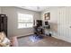 Bedroom with neutral walls featuring plush carpeting, a workstation, and natural light from a window at 53 Stafford Cir, Clayton, NC 27527