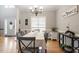Dining room with chandelier, hardwood floors, and view to the front yard at 53 Stafford Cir, Clayton, NC 27527