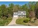 Charming two-story traditional home featuring a manicured front yard and a welcoming front porch at 53 Stafford Cir, Clayton, NC 27527