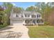 Two-story traditional home with attached two-car garage and inviting front porch with white railing at 53 Stafford Cir, Clayton, NC 27527