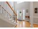 Inviting foyer featuring hardwood floors, staircase, and natural light at 53 Stafford Cir, Clayton, NC 27527