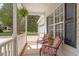 Cozy front porch featuring comfortable seating and a view of the manicured front yard at 53 Stafford Cir, Clayton, NC 27527