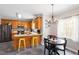 Cozy kitchen featuring a breakfast bar, stainless steel appliances, and dining area at 53 Stafford Cir, Clayton, NC 27527