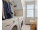 A convenient laundry room featuring a washer, dryer, and a window that lets in natural light at 53 Stafford Cir, Clayton, NC 27527