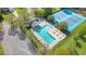 Aerial view of a community pool and tennis courts with ample seating and a covered pavilion at 53 Stafford Cir, Clayton, NC 27527