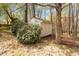 Backyard features a convenient storage shed surrounded by mature trees and lush greenery at 53 Stafford Cir, Clayton, NC 27527