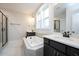 Luxurious bathroom with double vanity, soaking tub, and glass-enclosed shower for a spa-like retreat at 555 Vine Pkwy, Pittsboro, NC 27312
