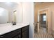 The bathroom features stylish tile flooring, a sleek vanity, and a bright, open doorway at 555 Vine Pkwy, Pittsboro, NC 27312
