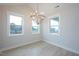 Bright dining room featuring large windows, and modern lighting at 555 Vine Pkwy, Pittsboro, NC 27312