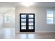 Beautiful entryway featuring a contemporary glass-paned door and bright, neutral decor at 555 Vine Pkwy, Pittsboro, NC 27312