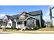 Charming two-story home with a stylish front porch and professionally landscaped yard at 555 Vine Pkwy, Pittsboro, NC 27312