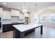 Spacious kitchen featuring a center island, stainless appliances, and white cabinetry at 555 Vine Pkwy, Pittsboro, NC 27312