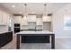 Spacious kitchen featuring a center island, stainless appliances, and white cabinetry at 555 Vine Pkwy, Pittsboro, NC 27312